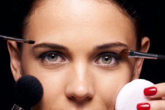 A beautiful young woman having various make up techniques tried on her face