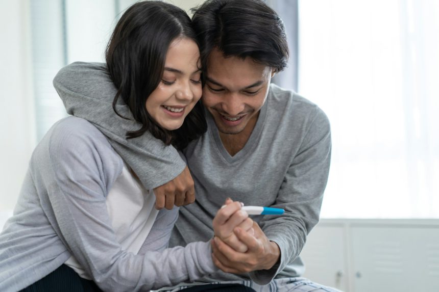 Asian young couple feeling happy after look at positive pregnancy test. Family-Expecting baby