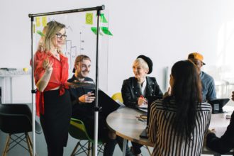 Portrait of young female team leader of talented freelances organizing work of members motivates and