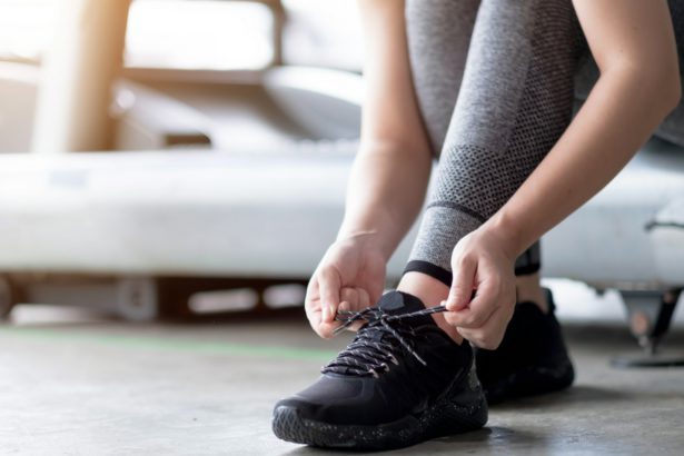 Sports Shoes. Woman Hands Tying Shoelaces On Fashion Sneakers